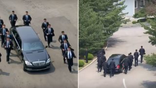 Kim Jong Un’s bodyguards run alongside his limo as he heads for lunch