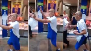 Butcher swings his meat around at vegan protesters outside his shop