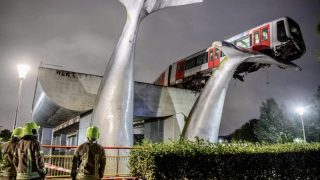 Dutch train crashes through barrier and lands on giant whale sculpture
