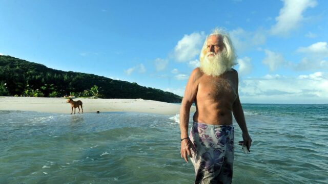 Millionaire Castaway is seeking help on his secluded island as 80th birthday looms